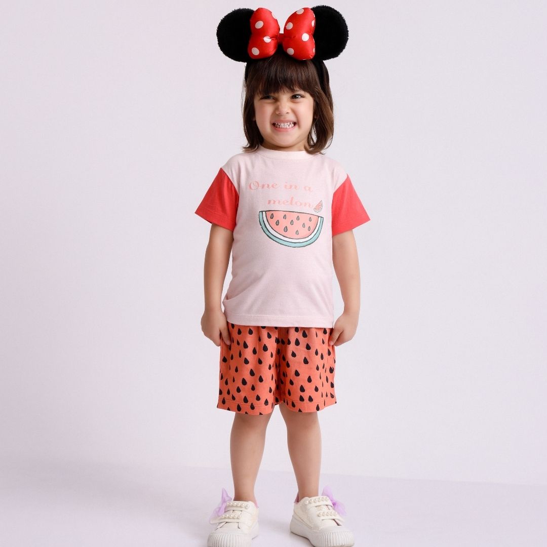 One In A Melon Cotton T-Shirt & Shorts Set: a child wearing a white t-shirt with a watermelon slice and the words "One In A