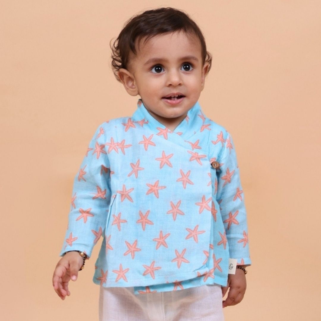 Coral Starfish Muslin Angrakha Set: A woman wears a flowing, intricately patterned angrakha dress with a starfish motif.