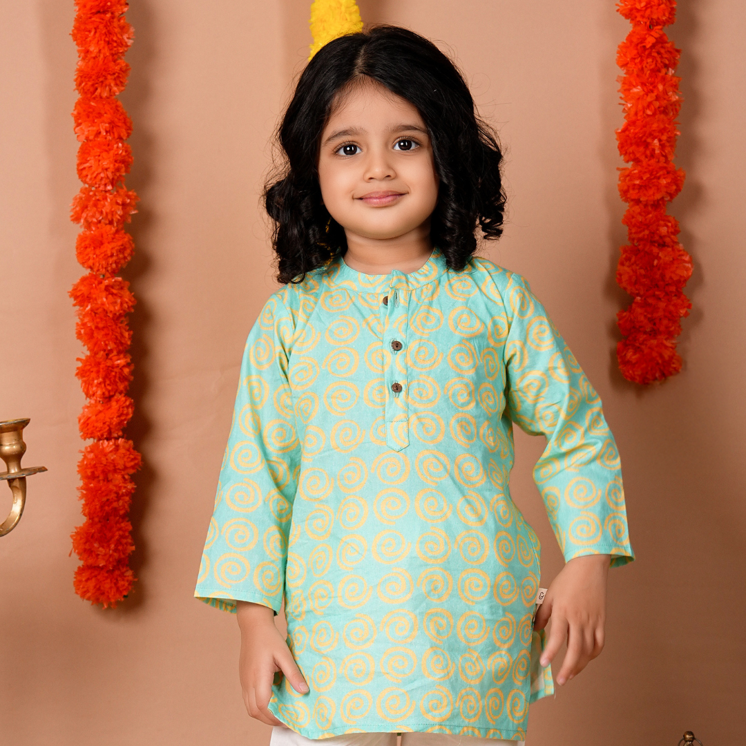 Bright Spiral Kurta Set: A woman models a vibrant kurta with a swirling spiral pattern in shades of blue and pink.