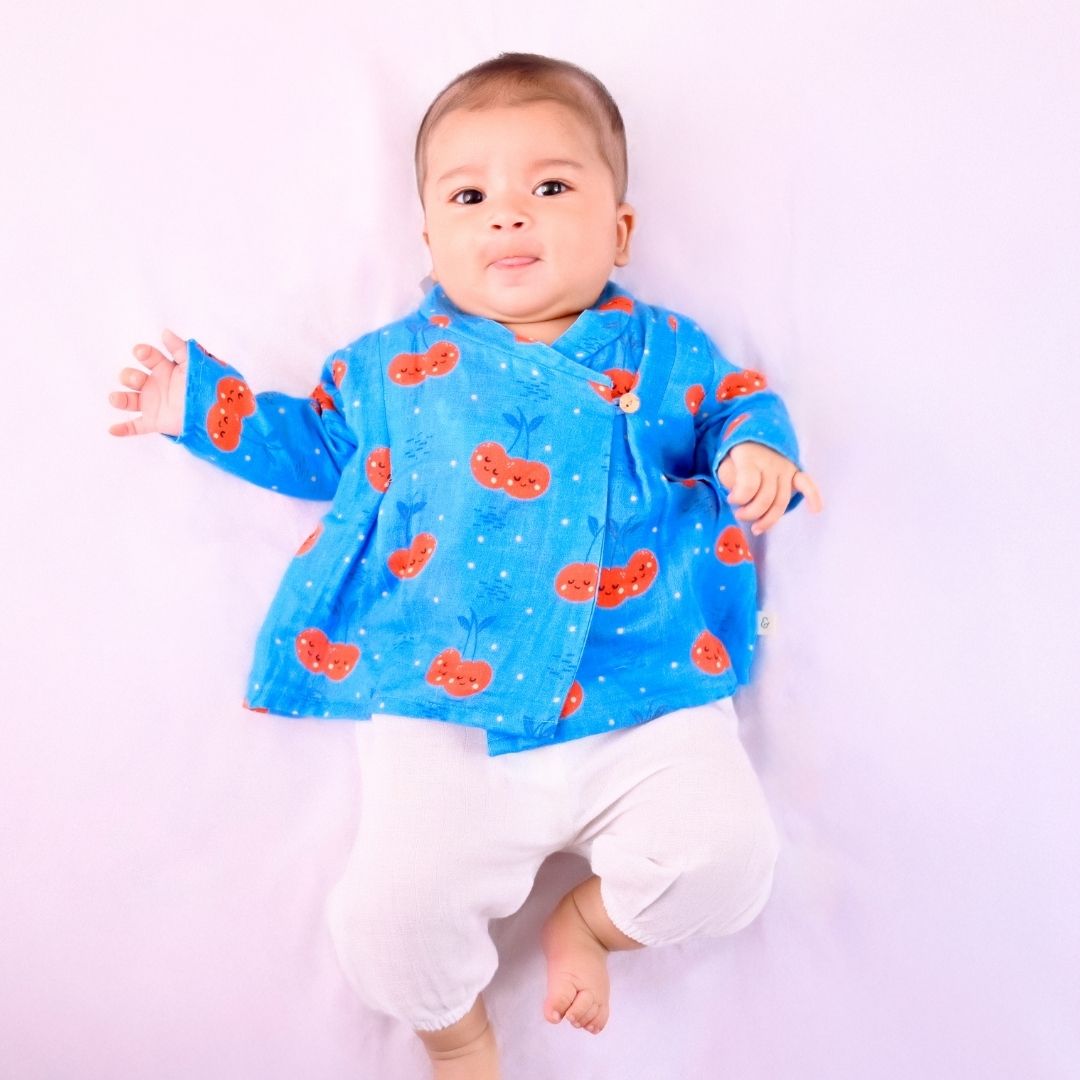 Cheeryful Muslin Angrakha Set: A woman in a vibrant, floral-printed angrakha with a matching dupatta.