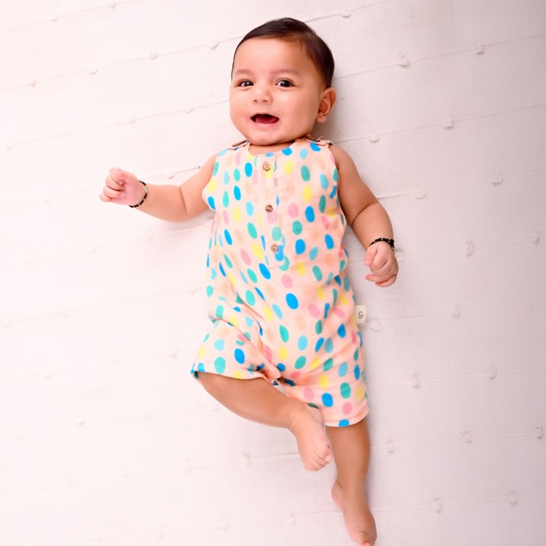 Colorful Polka Muslin Double Layer Romper with white polka dots on a teal background.