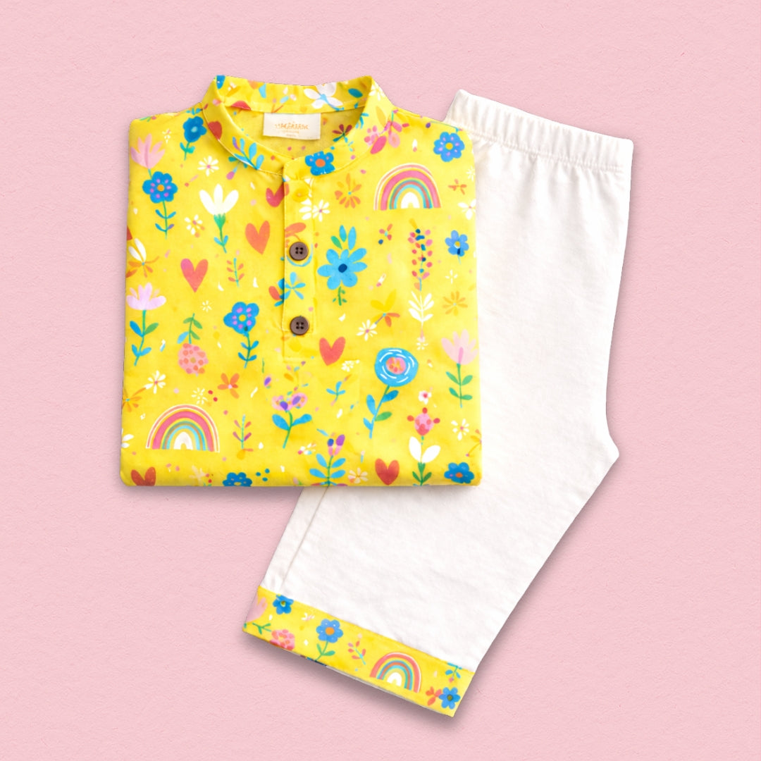 Yellow floral cotton kurta set for women, featuring a vibrant floral print on a yellow base with coordinating bottoms.