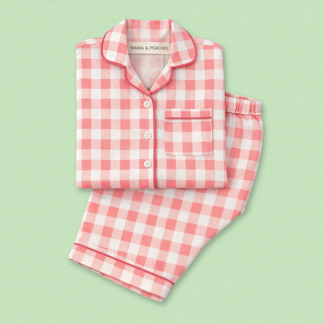 Pink gingham full sleeves night suit with a button-up top and matching pants.