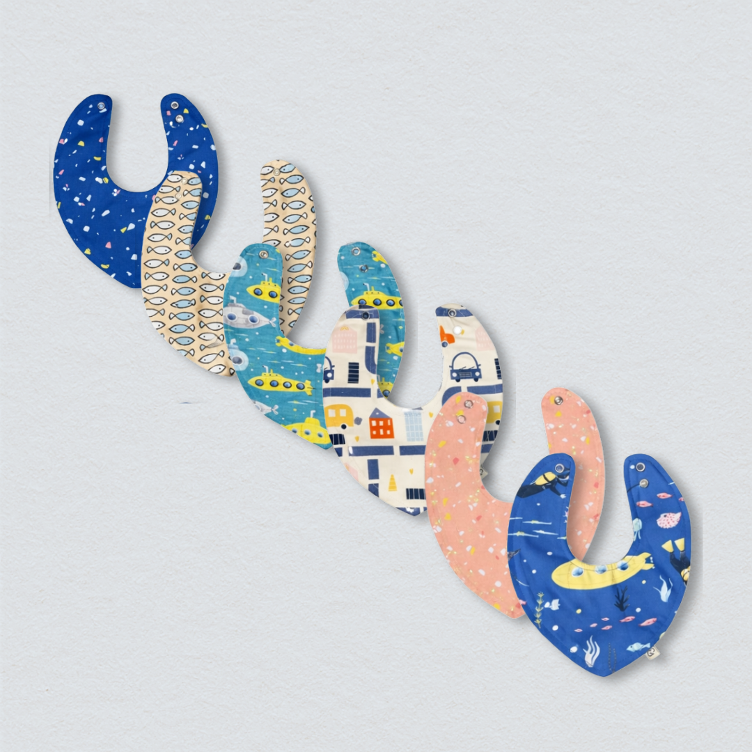 Cotton Bibs Bundle: A set of three soft, white cotton bibs with a blue trim.