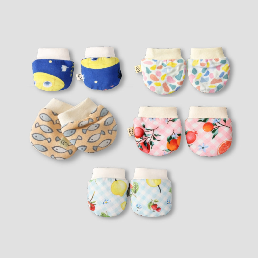 A bundle of soft, cream-colored Cotton Mittens, perfect for cozy hands.